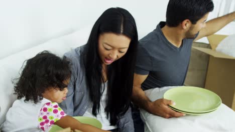 Asian-Chinese-family-relaxing-after-home-move-unpacking