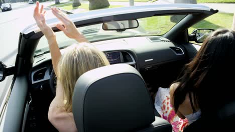 Caucasian-girls-enjoying-glamorous-lifestyle-driving-luxury-car