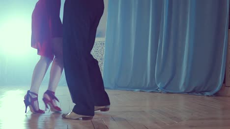 Legs-of-couple-learning-to-dance-tango-in-the-studio.-Close-up