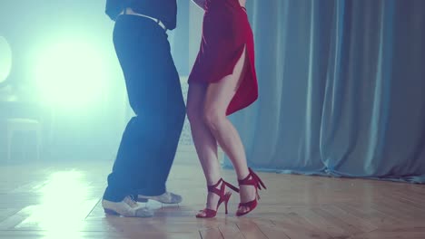 Legs-of-couple-learning-to-dance-tango-in-the-studio.-Close-up