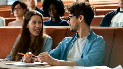 In-the-Classroom-Female-and-Male-Students-Chatting-on-a-Lecture.-Young-People-Talking-and-Becoming-Friends.-College-Life.