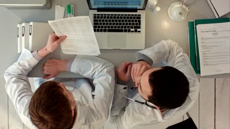 Top-view-of-Team-of-pharmacists-discuss-about-new-pills-at-the-office