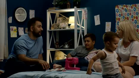 Man-telling-stories-to-family-on-bed