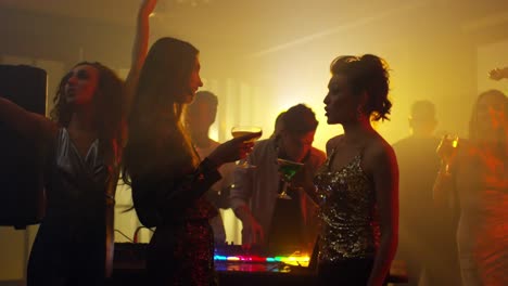 Female-Friends-Talking-on-Dance-Floor