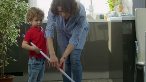 Mother-Teaching-Son-to-Mop-Floor