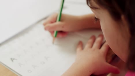 Little-girl-preparing-her-English-homework