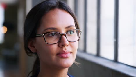 Young-businesswoman-wearing-glasses-smiling,-close-up