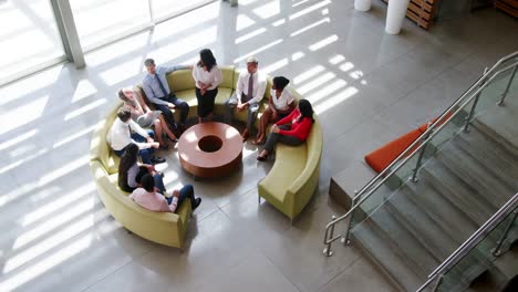 Businesswoman-presenting-at-team-meeting,-elevated-view