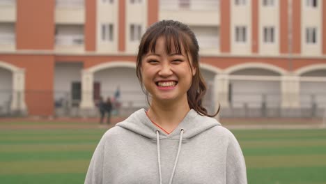 Portrait-of-young-asian-girl-smile-at-camera-in-campus