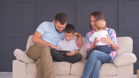 Happy-family-with-digital-tablet-at-home