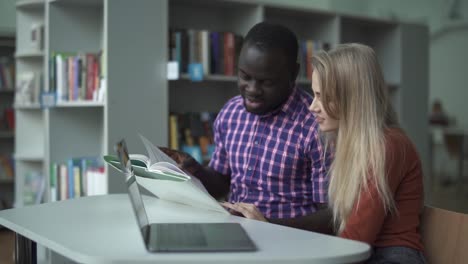 Interracial-students-leafing-through-a-book