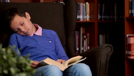 cute-schoolboy-uses-the-app-on-his-smartphone-while-sitting-in-a-chair