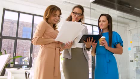 businesswomen-with-tablet-pc-and-charts-at-office