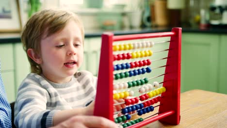 Father-Teaching-Son-To-Count-Using-Abacus