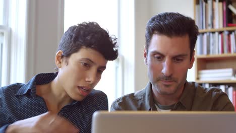 Businesspeople-Using-Laptop-At-Desk-In-Office-Shot-On-R3D