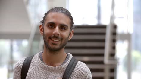 Asian-male-university-student-walking-into-focus-indoors