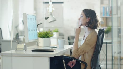 Mujer-pelo-corto-creativa-trabaja-cuidadosamente-en-su-escritorio.-Los-sorbos-de-café-de-una-taza-y-piensa-en-la-solución-de-problemas.