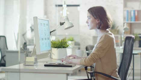 Creative-Brunette-Working-on-Design-at-Her-Desktop-Computer.-Sitting-in-Her-developer-Office.