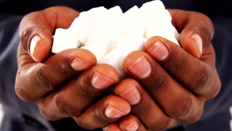 Hands-of-businessman-holding-sugar-cubes