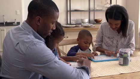 Parents-And-Children-Drawing-On-Whiteboards-At-Table