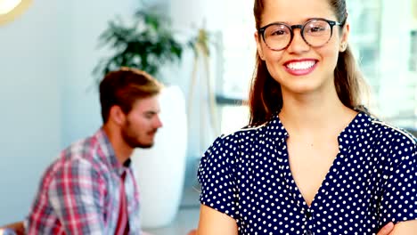 Portrait-of-female-executive-standing-with-arms-crossed