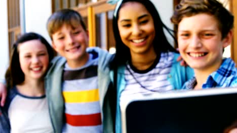 Smiling-schoolkids-taking-selfie-with-mobile-phone