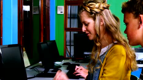 Students-interacting-while-using-computer-in-classroom