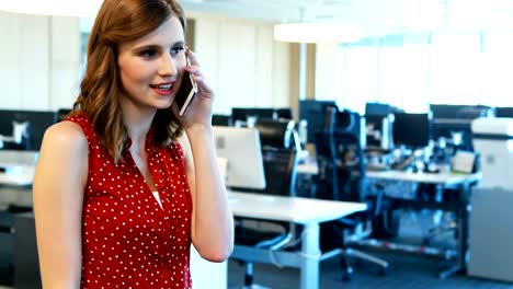 Female-executive-talking-on-mobile-phone