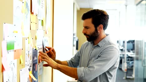 Male-executive-looking-at-bulletin-board