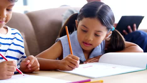 Girl-and-boy-doing-homework-in-living-room