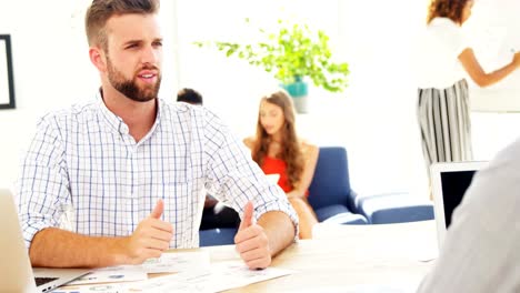 Business-colleagues-shaking-hands-in-the-office