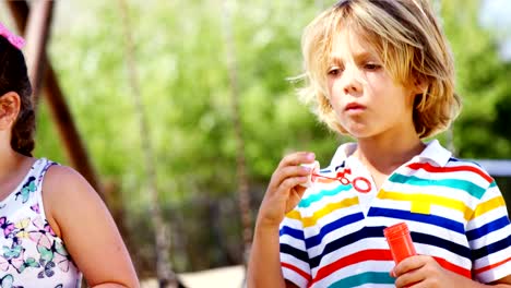 Schoolkids-playing-with-bubble-wand-in-playground