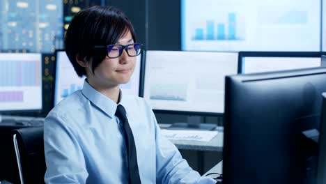 In-the-Data-Mining-Center-Statistician-sits-at-His-Workstation-Surrounded-with-Monitors-Displaying-Data-and-Graphs.