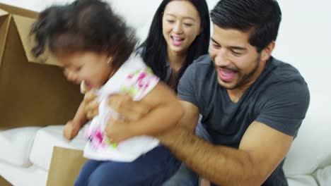 Asian-Chinese-family-relaxing-after-home-move-unpacking