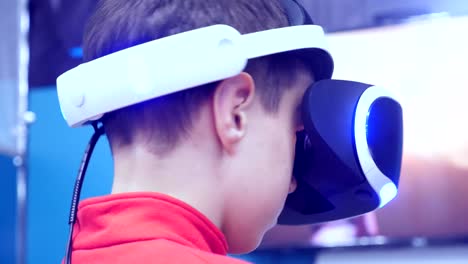 the-boy-in-virtual-reality-glasses-is-playing.