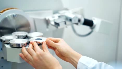 Closeup-of-a-scientist-putting-test-sample-into-analyzing-laboratory-machine