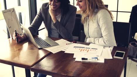 Two-young-beautiful-businesswoman-have-meeting-and-discussing-about-monthly-sale-report,-Business-and-finance-concept.