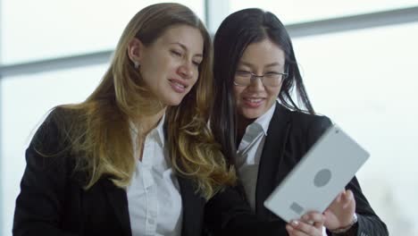 Cheerful-Businesswomen-with-Tablet