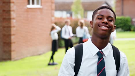 Portrait-Of--Male-Teenage-Student-In-Uniform-Outside-School