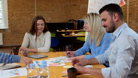 Business-team-meeting-involved-diverse-people-participating-in-creative-sustainable-ideas-steadicam-shot-across-boardroom-table-shared-work-space