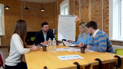 Business-team-meeting-involved-diverse-people-participating-in-creative-sustainable-ideas-steadicam-shot-across-boardroom-table-shared-work-space