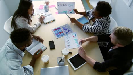 African-Businesswoman-Explaining-Diagrams-to-Coworkers