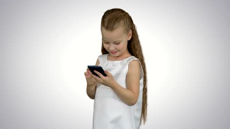 Little-girl-using-smartphone-on-white-background