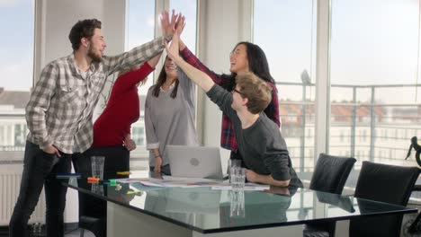 Enthusiastic-startup-members-cheering-after-finishing-a-successful-meeting