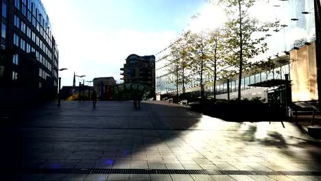 employees-move-between-buildings-with-glass-showcases-and-windows