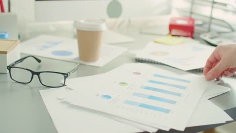 Closeup-Of-Businesswoman-Hand-Analyzing-Graphs-At-Desk-4K