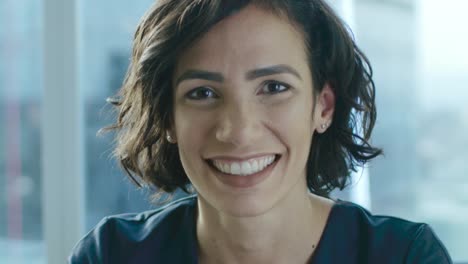 Portrait-of-a-Beautiful-Hispanic-Woman-Smiling-Charmingly-Stepping-into-Focus.