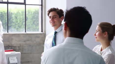 Senior-female-boss-talking-to-colleagues-in-a-meeting-room