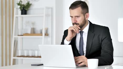 Shocked-Businessman-Working-on-Laptop,-Astonished