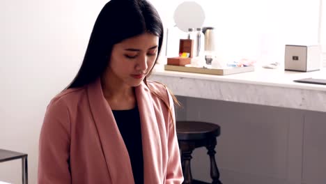 Business-women-using-tablet-in-the-room-at-hotel.